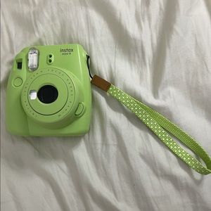 like green Polaroid camera, plus lots so side accessories